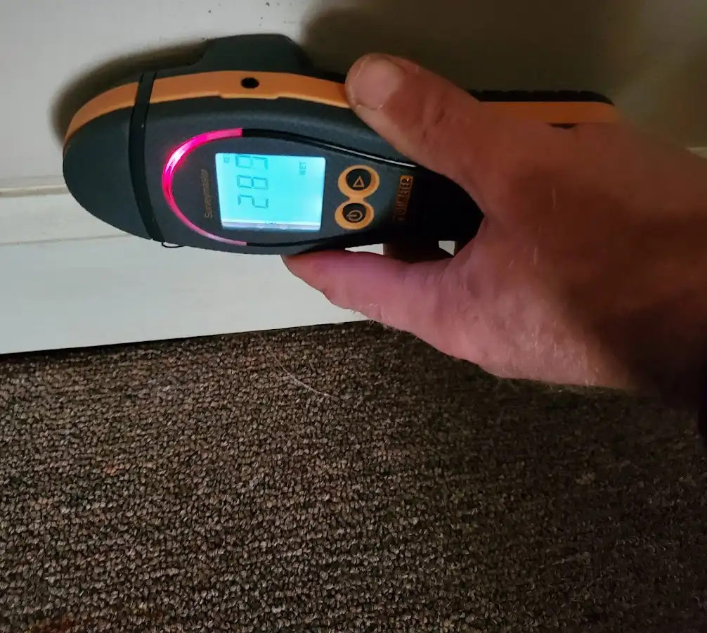 Moisture detection at baseboard during Storm Damage Restoration in Marquette